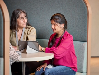 Two Atradius colleagues working in a breakout area