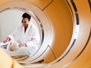 Medical scanning machine with patient and doctor in the back ground