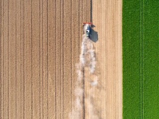 Over head view of farming tractor ploughing a field