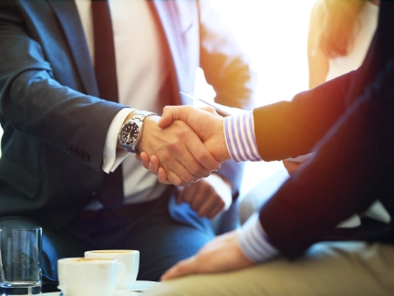 business people shaking hands finishing up a meeting