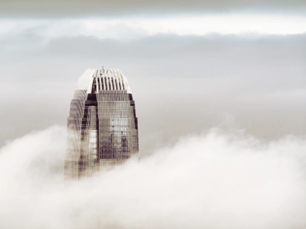 Skyscrapper building peaking through the clouds