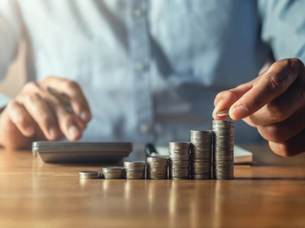 saving money with hand putting coins on stack concept financial